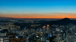 Seoul apartment skyline at dusk showing high-rise residential buildings along the Han River representing the Korea housing crisis 2026