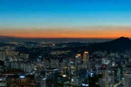 Seoul apartment skyline at dusk showing high-rise residential buildings along the Han River representing the Korea housing crisis 2026
