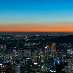 Seoul apartment skyline at dusk showing high-rise residential buildings along the Han River representing the Korea housing crisis 2026